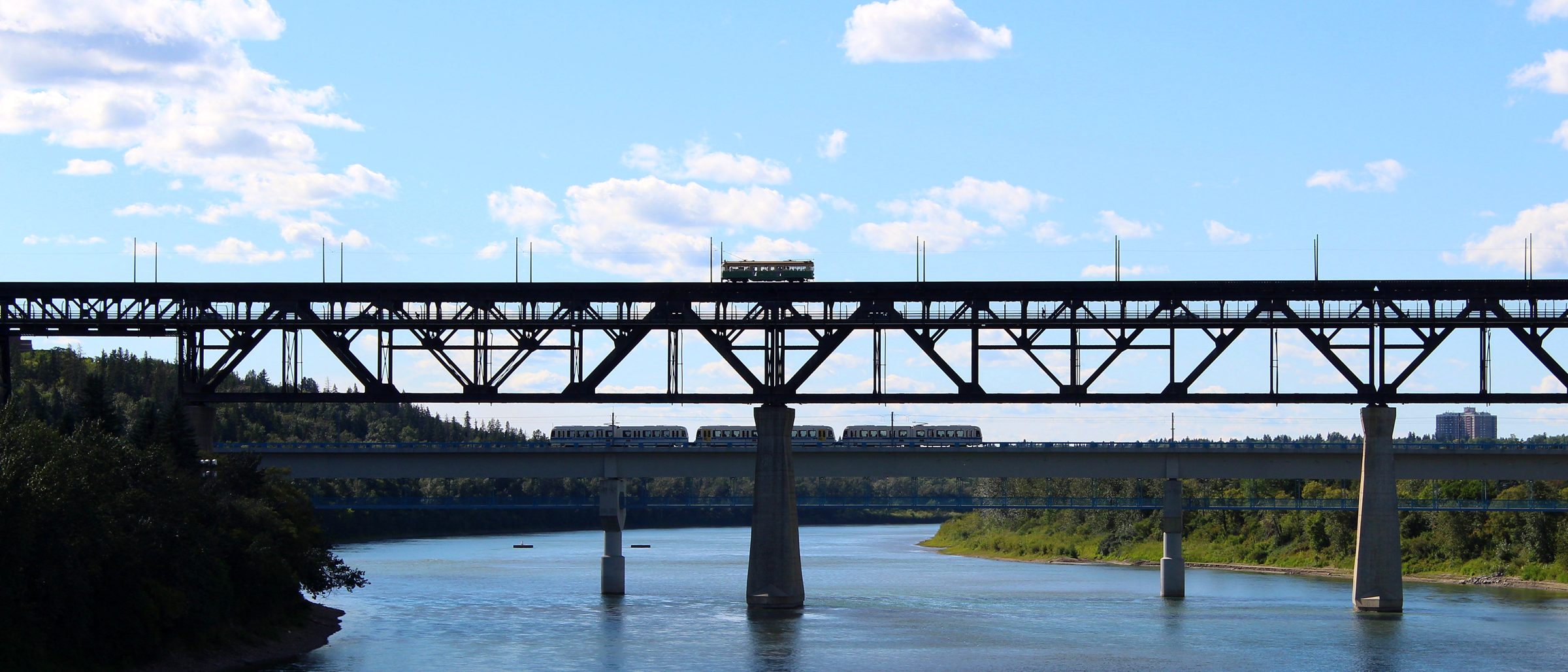 A restored streetcar crossing the High Level Bridge above an LRT train on the Dudley B. Menzies bridge, Edmonton